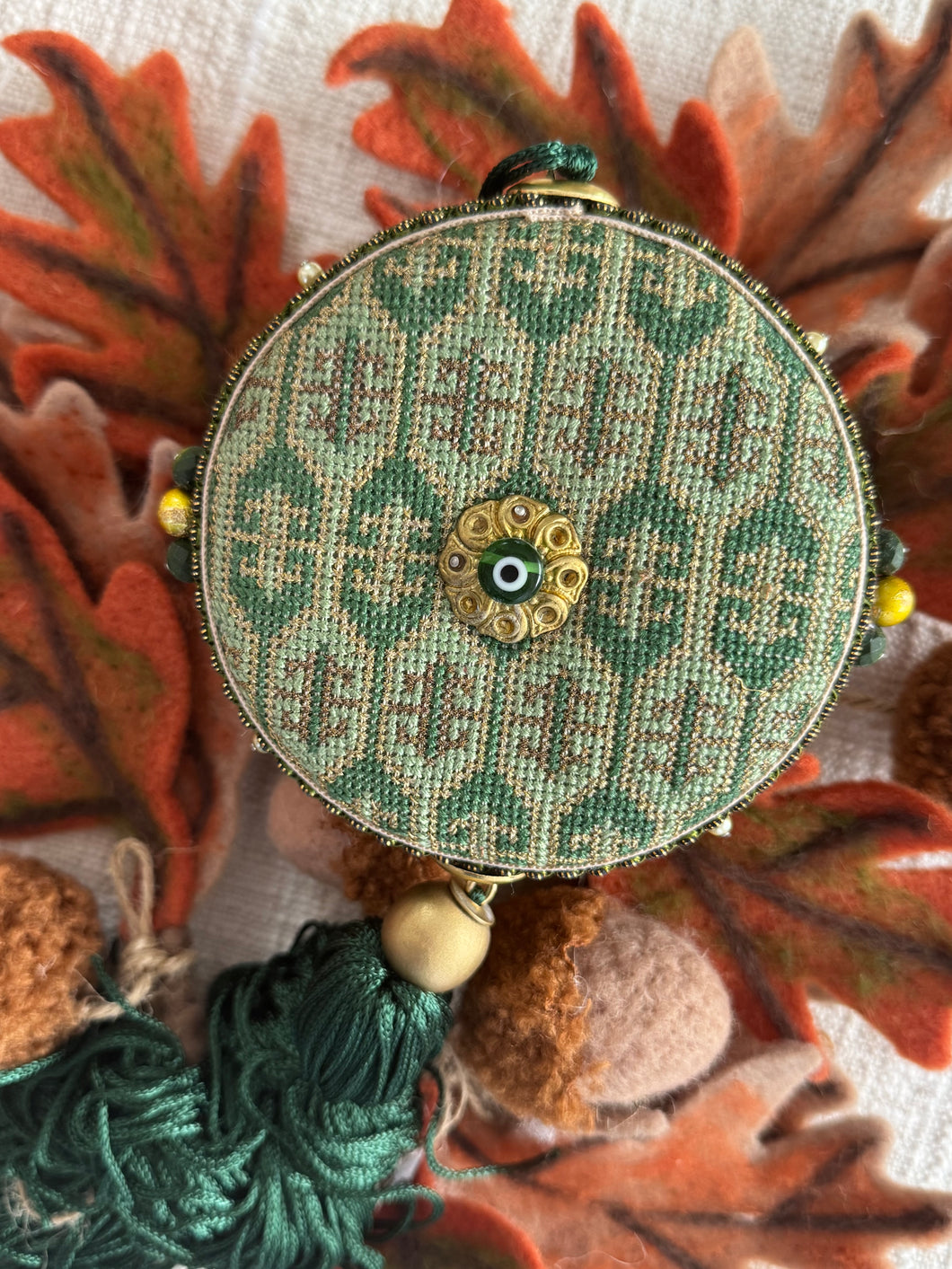 Round shaped charm in Green with gold details .🧿